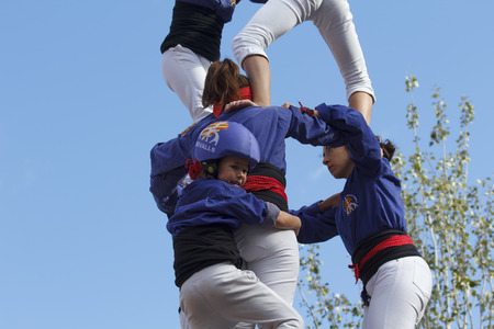 TARRAGONA - SPAIN. NOVEMBER 06, 2016 - People making human towers, a traditional spectacle in Catalonia called "castellers", with people climbing and making high structures in the city of Tarragonaのeditorial素材