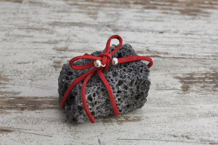 Christmas coal with red ribbon, sweet gift for naughty boysの写真素材