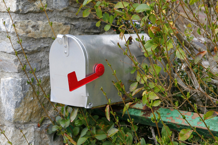Metallic closed mailbox with red indicatorの写真素材
