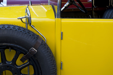 Old classic car detail, in yellow colorの写真素材