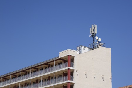 Telecommunications and mobile antennas in a rooftop of a buildingの写真素材