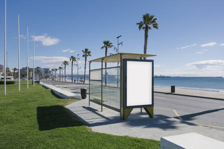 Blank advertisement in a bus stop, next to the seaの写真素材