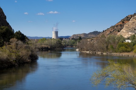 Steam chimney in a power nuclear plant, next to the riverの写真素材