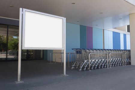 Blank billboard mock up in a supermarket, in front of shopping cartsの写真素材