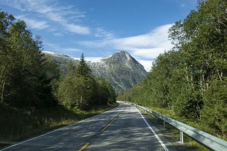 Mountain road with Josteldalsbreen glacier in the background, Norwayの写真素材