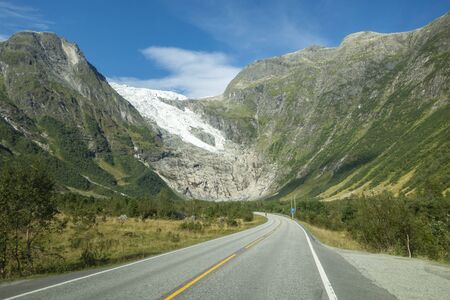 Mountain road with Josteldalsbreen glacier in the background, Norwayの写真素材