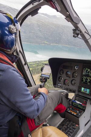 Pilot in the interior of an helicopter during a flightの写真素材