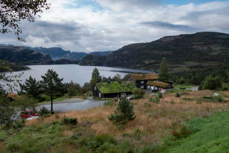 Traditional norwegian wooden houses with grass on the roof. Typical Norway architectureの写真素材