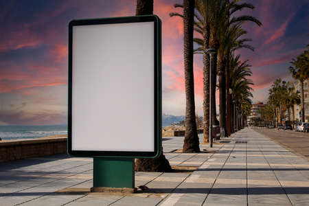Blank billboard in a footpath, next to the seaの写真素材