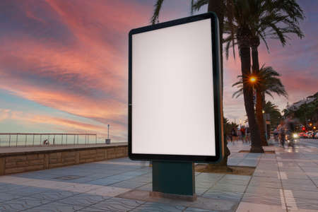 Blank billboard in a footpath, next to the seaの写真素材