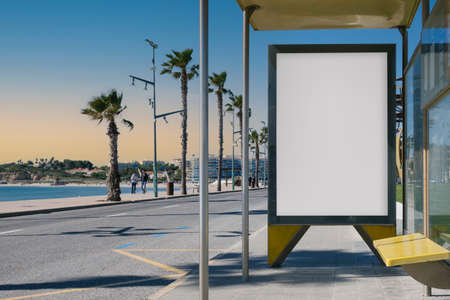 Blank advertisement in a bus stop, next to the seaの写真素材