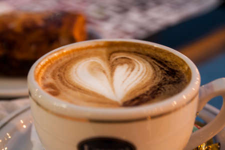 cup of caffe with milk and heart forms