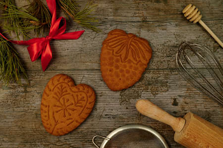 Christmas gingerbread with kitchen tools and plants on the rustic backgroundの写真素材