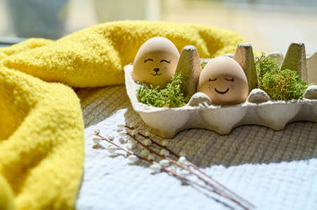 Easter eggs and other easter decorations by the windowの写真素材