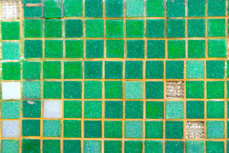 Old green mosaic tiles on the wallの写真素材