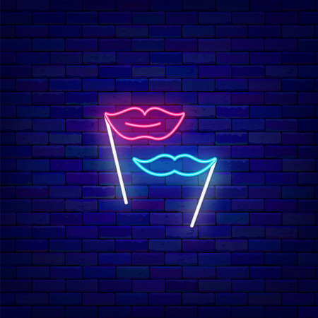 Lips and mustache on a stick neon icon. Masquerade Accessory. Diverse photo booth props. Glowing effect banner. Holiday celebration design on brick wall. Editable stroke. Vector stock illustrationの写真素材
