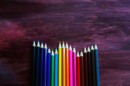 coloured pencils on brown backgroundの写真素材