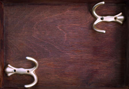 Two horizontal gold hooks into old dark boxの写真素材