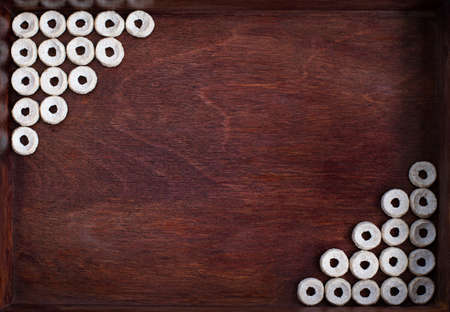 oat cereal lined as two angles into dark wood box