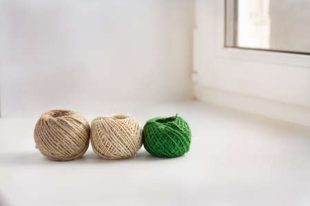 Three skeins of thread in a row on the windowsillの写真素材
