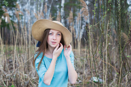 Freckled girl in hat looking at camera in the springの写真素材