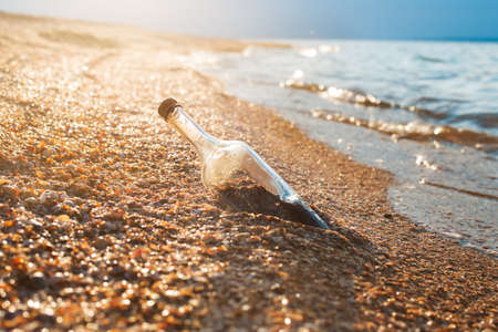 Sealed bottle on the shore of the seaの写真素材