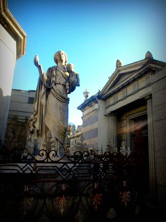 statue of angel in front of churchの写真素材