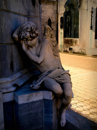 statue of angel in front of churchの写真素材