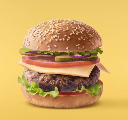 Delicious burger isolated on yellow backgroundの写真素材