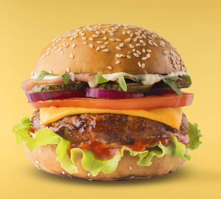 Delicious burger isolated on yellow backgroundの写真素材