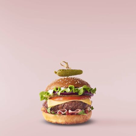 Delicious burger isolated on pink backgroundの写真素材