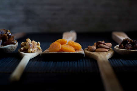 Dried Fruit and Nuts on Wooden Spoons - Selective focusの写真素材