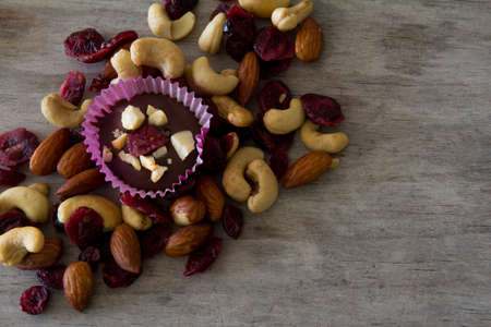 Chocolate and Nut Treat on Table Surrounded with Nutsの写真素材