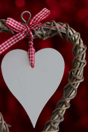 Wooden Heart with Ribbon on Redの写真素材