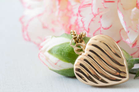 Close Up Heart Locket and Flowersの写真素材