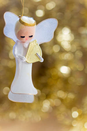 Angel with a Harp on a Golden Background with Copy Space, Selective Focusの写真素材
