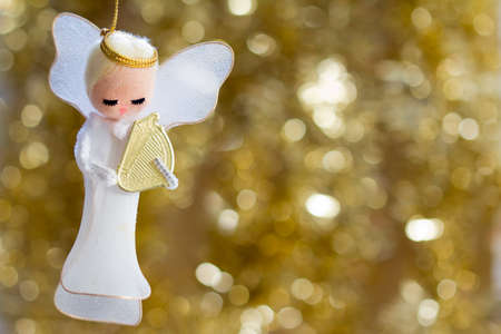 Angel with a Harp on a Golden Background with Copy Space, Selective Focus - Horizontalの写真素材