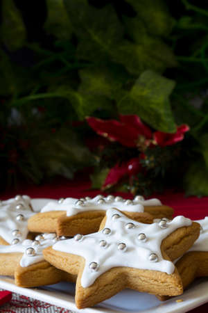 Decorated Christmas Star Cookies with Bowls of Sugar Pearls Vertical