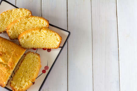 Madeira Cake from Above on White Wooden Table with Copy space