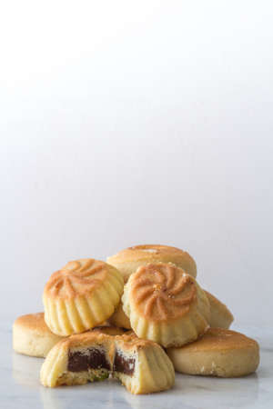 Middle Eastern Eid Cookies Filled with Dates in a Stack on Light Background Copy Space Verticalの写真素材