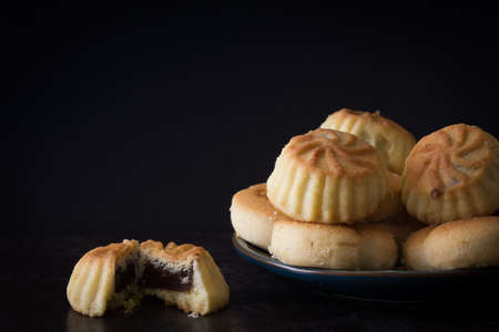 Middle Eastern Eid Cookies Filled with Dates on Dark Background Horizontal with Copy Spaceの写真素材