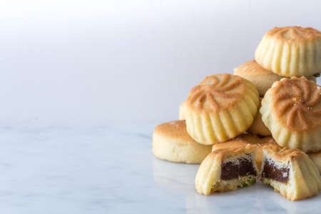 Close Up Middle Eastern Eid Cookies Filled with Dates in a Stack on Light Background Copy Space Horizontalの写真素材