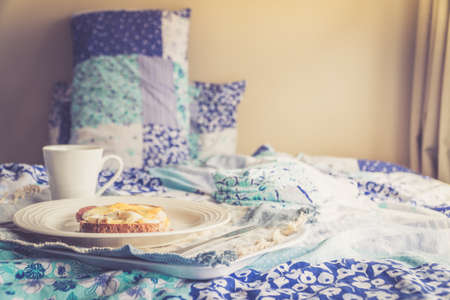 Close Up of Bacon and Egg Breakfast on a Bedの写真素材