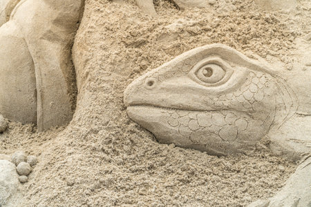 OREWA, NZ - MAR 23: Close Up of Sand Sculpture of the Head of a Lizard at the Orewa Sand Castle Competition Mar 23 2019のeditorial素材