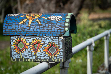 Beautiful Mosaic Letter Box on a Fence in Sunshineの写真素材