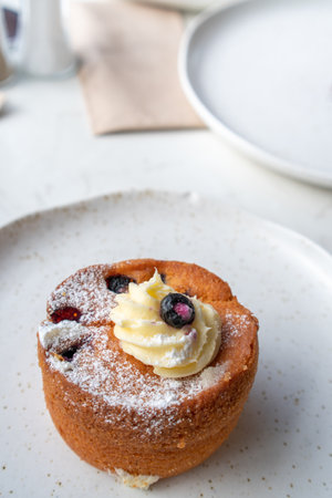 Blueberry and Cream Cheese Cupcake on a Plate with Copy Spaceの写真素材