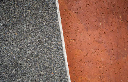 Close-Up of Textured Concrete Surface Grey and Red Ochre with Copy Space