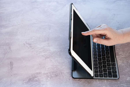 Close-Up of Woman Using Tablet with Blank Screen on Table with Copy Space Top Side View
