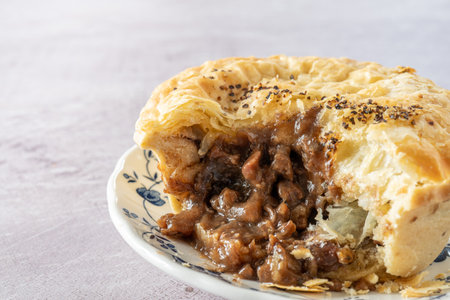 Steak and Black Pepper Pie Cut Open on a Plate with Selective focusの写真素材