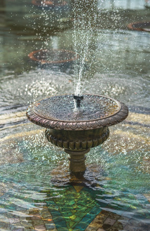 Beautiful Water Fountain in a Pond on a Sunny Morningの写真素材